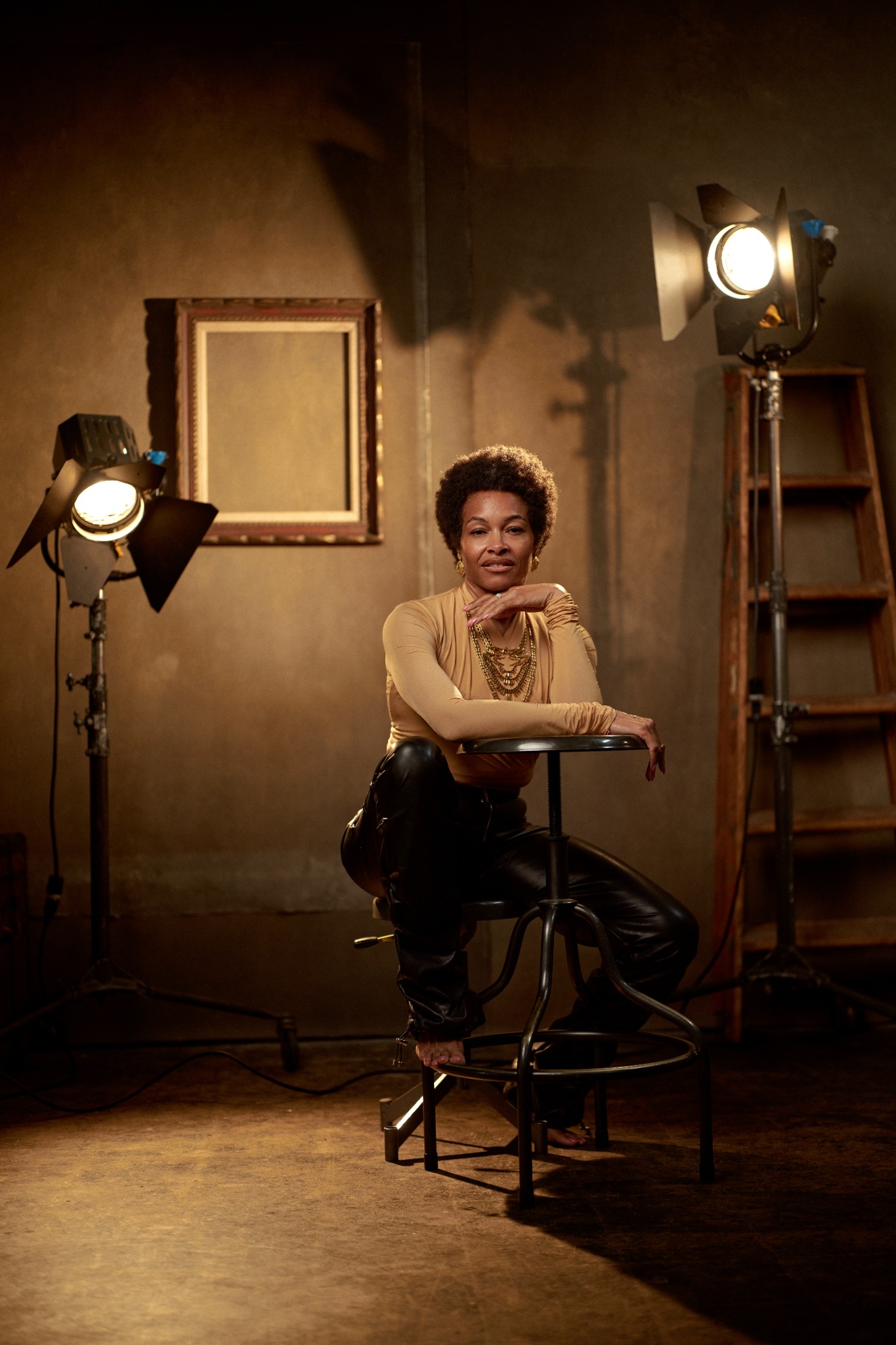 Dawn seated in a warmly lit photography studio