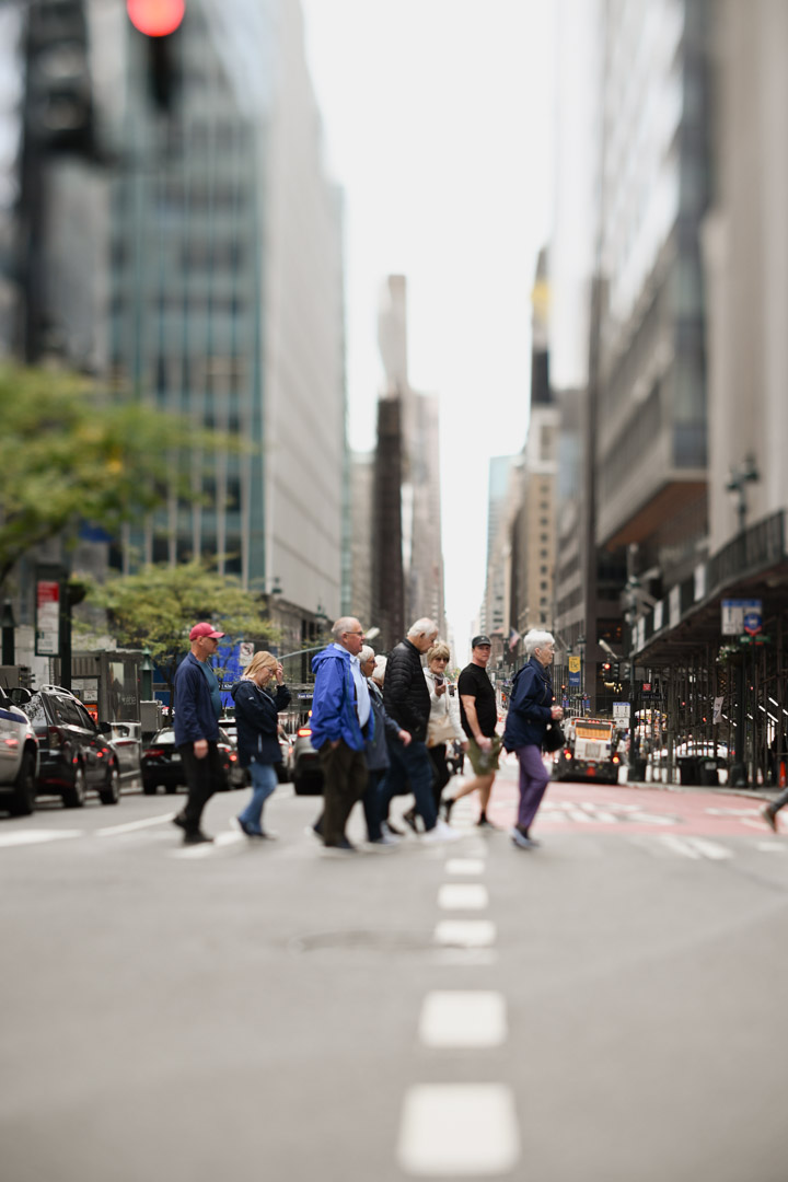 A group walks across a Manhattan intersection