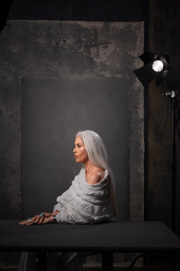 Profile studio portrait of a silver-haired woman