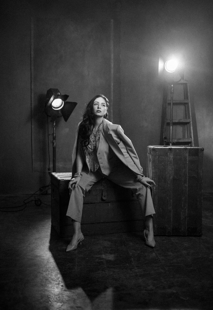 Black and white studio portrait of a woman in a suit